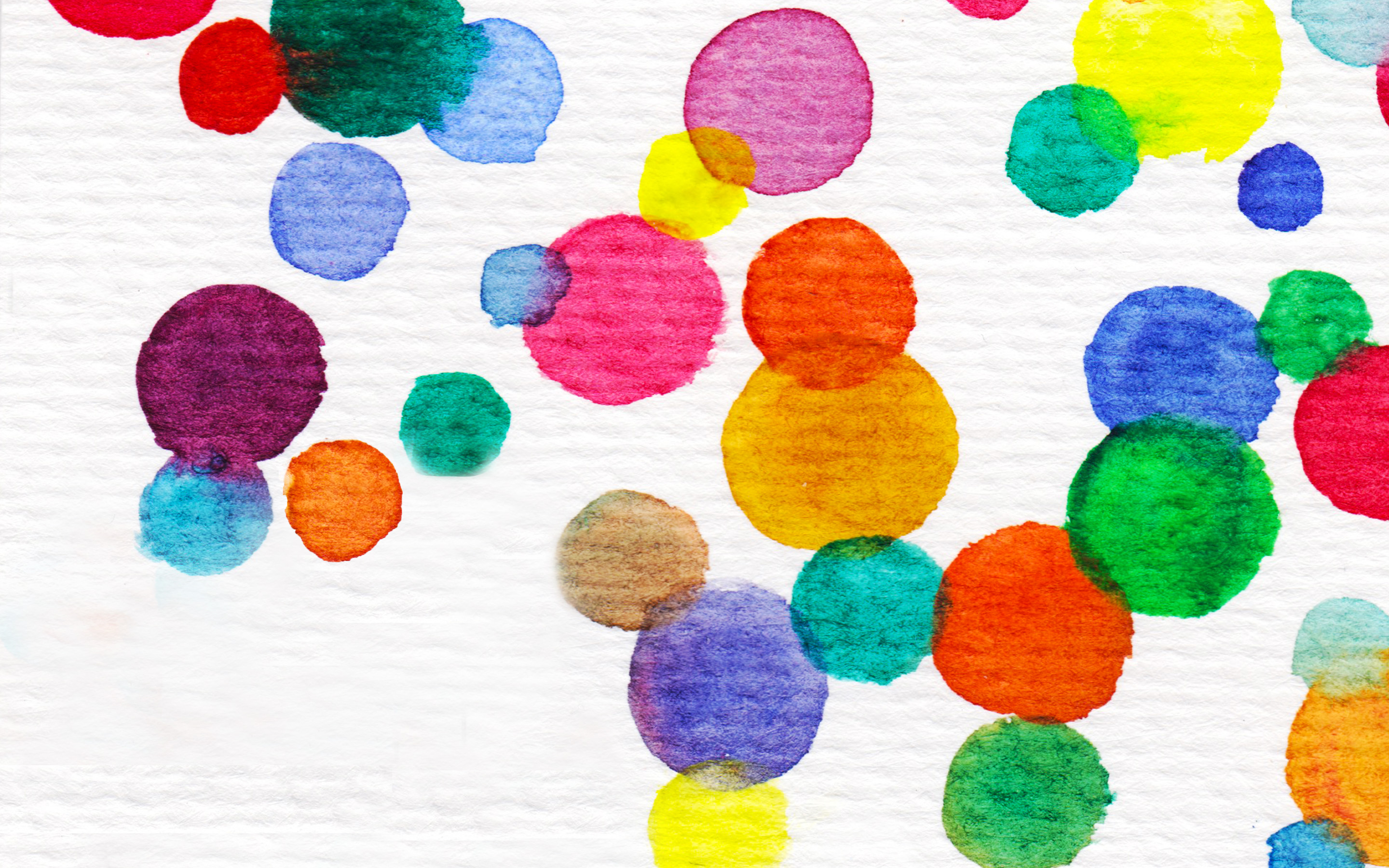 Abstract watercolor painting with multicolored circles of varying sizes on a textured white background.