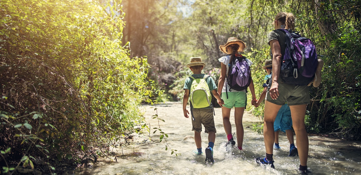 Mother and kids hiking in Andalusia river of Rio Chillar