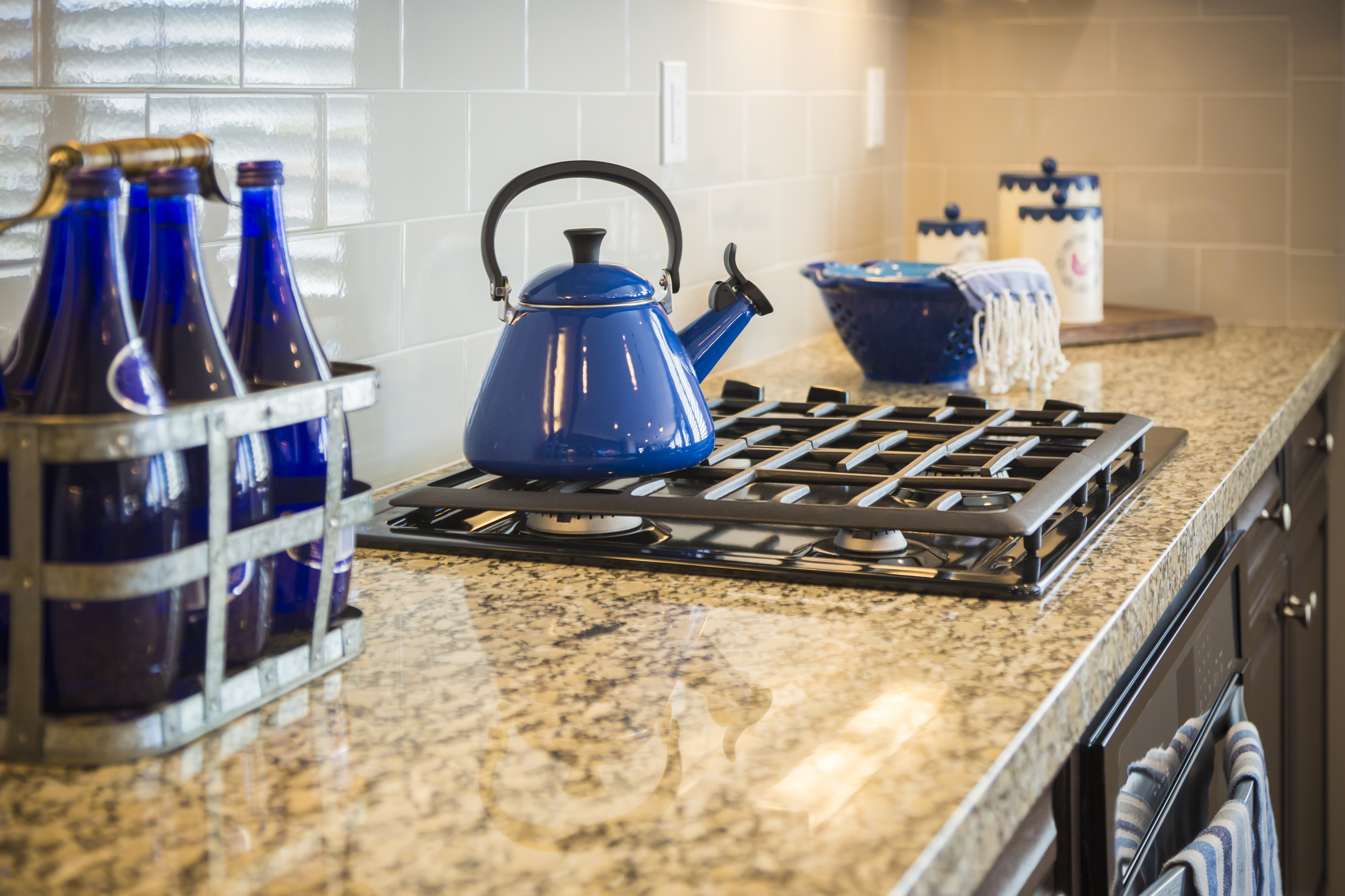 Bautiful Marble Kitchen Counter and Stove With Cobalt Blue Decor.