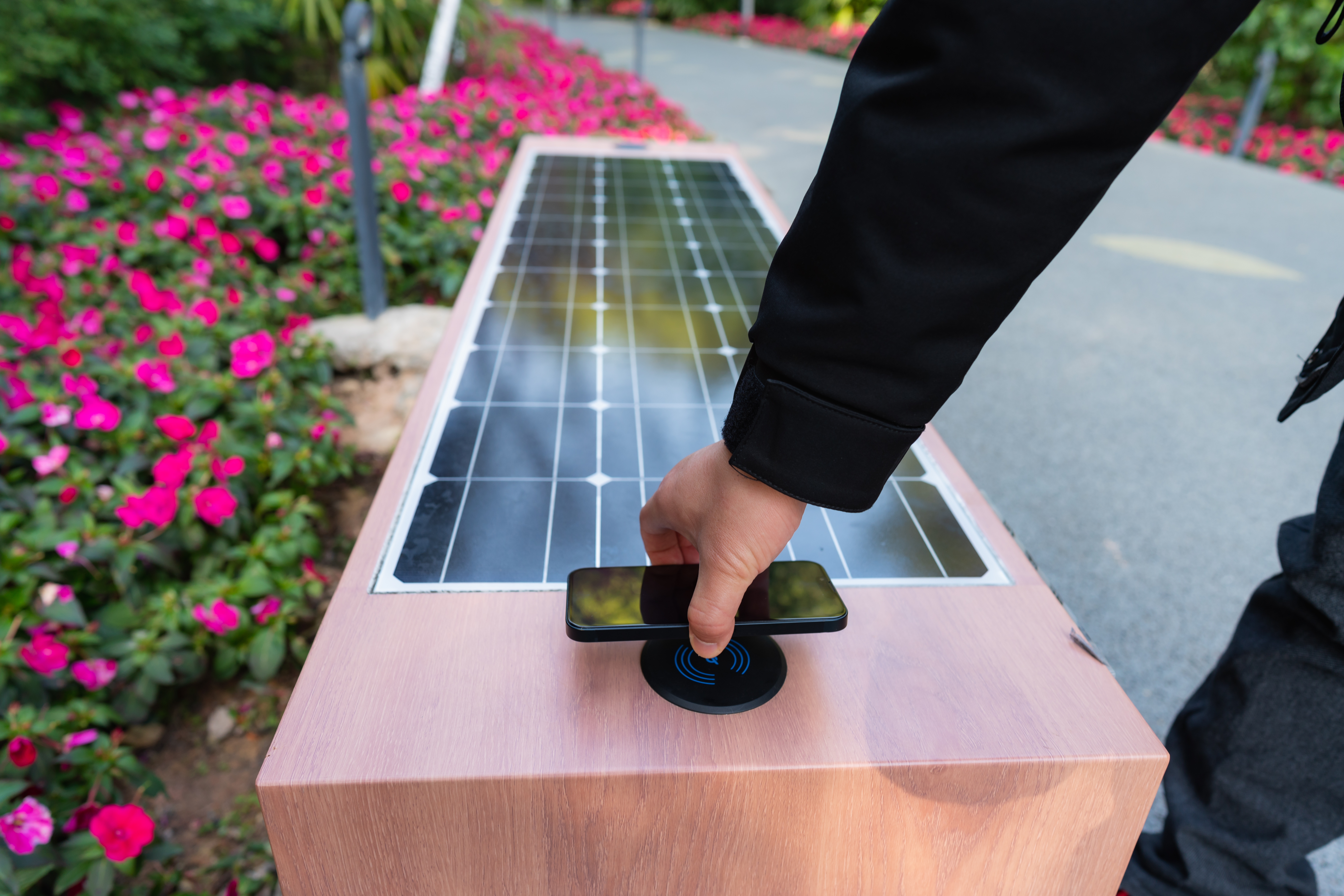 Man using solar powered seat with wireless charging function