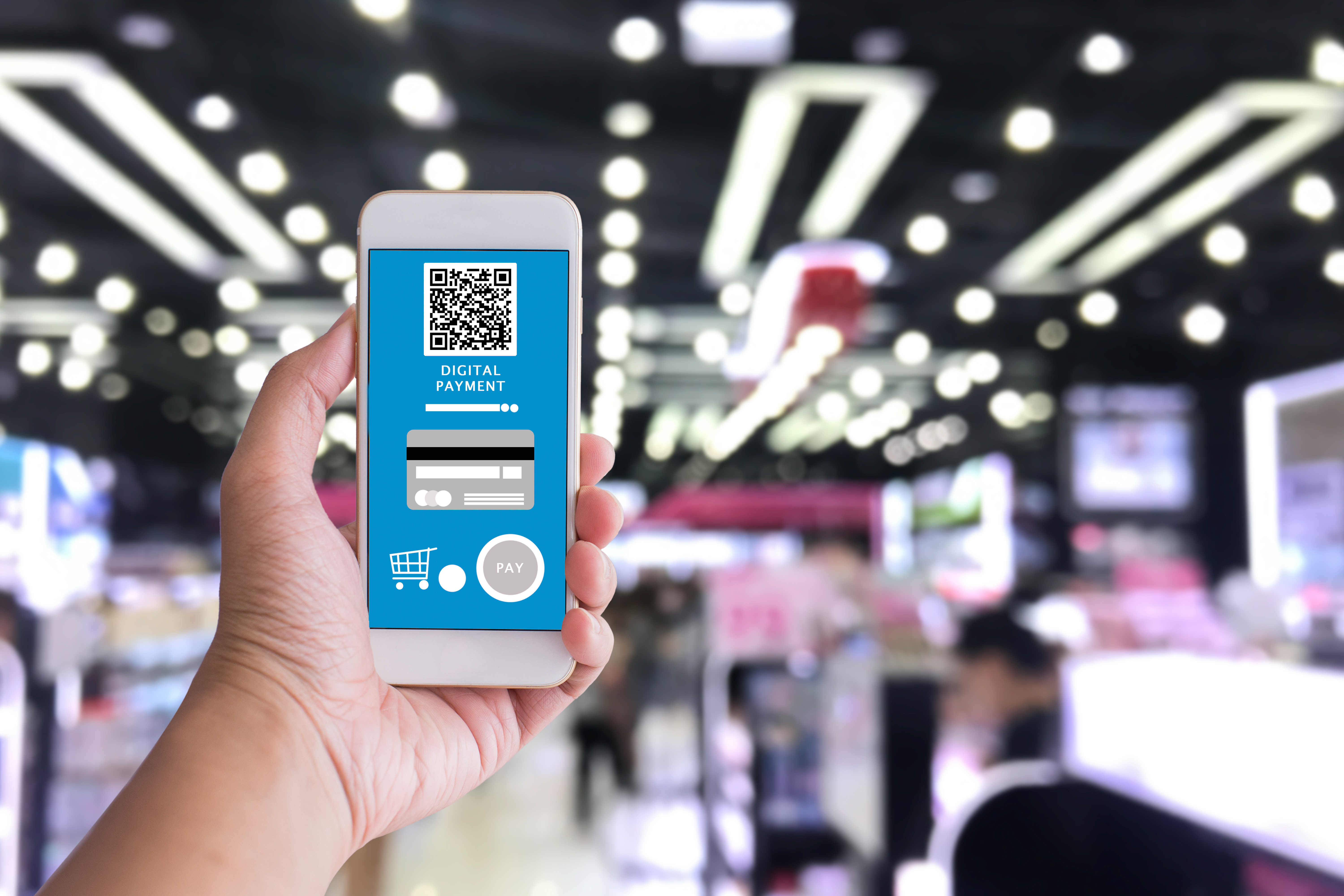 Digital payment concept,close up smart phone and blurred shop ba