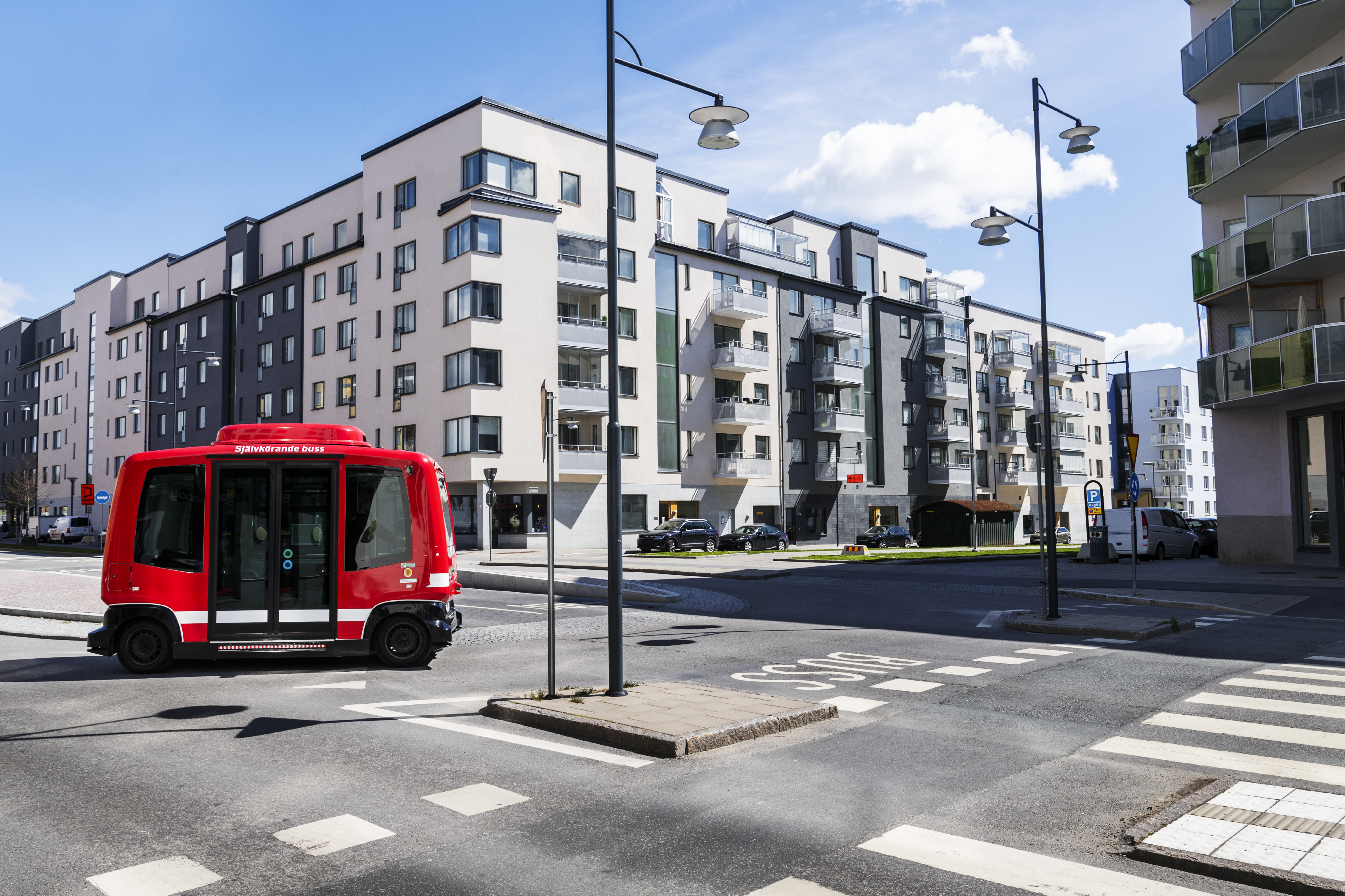 Bus on road, blocks of flats on background
