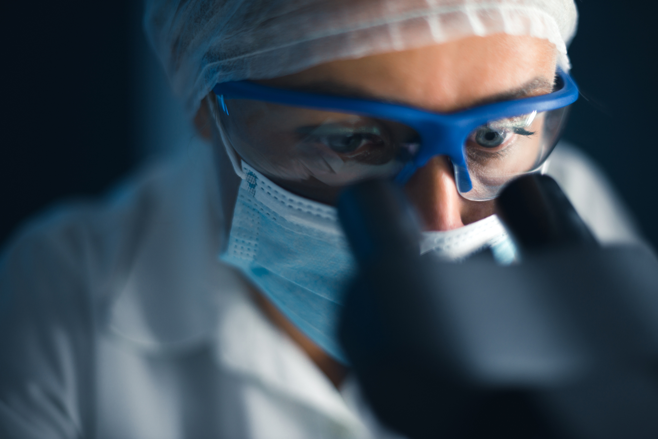 Looking into a microscope